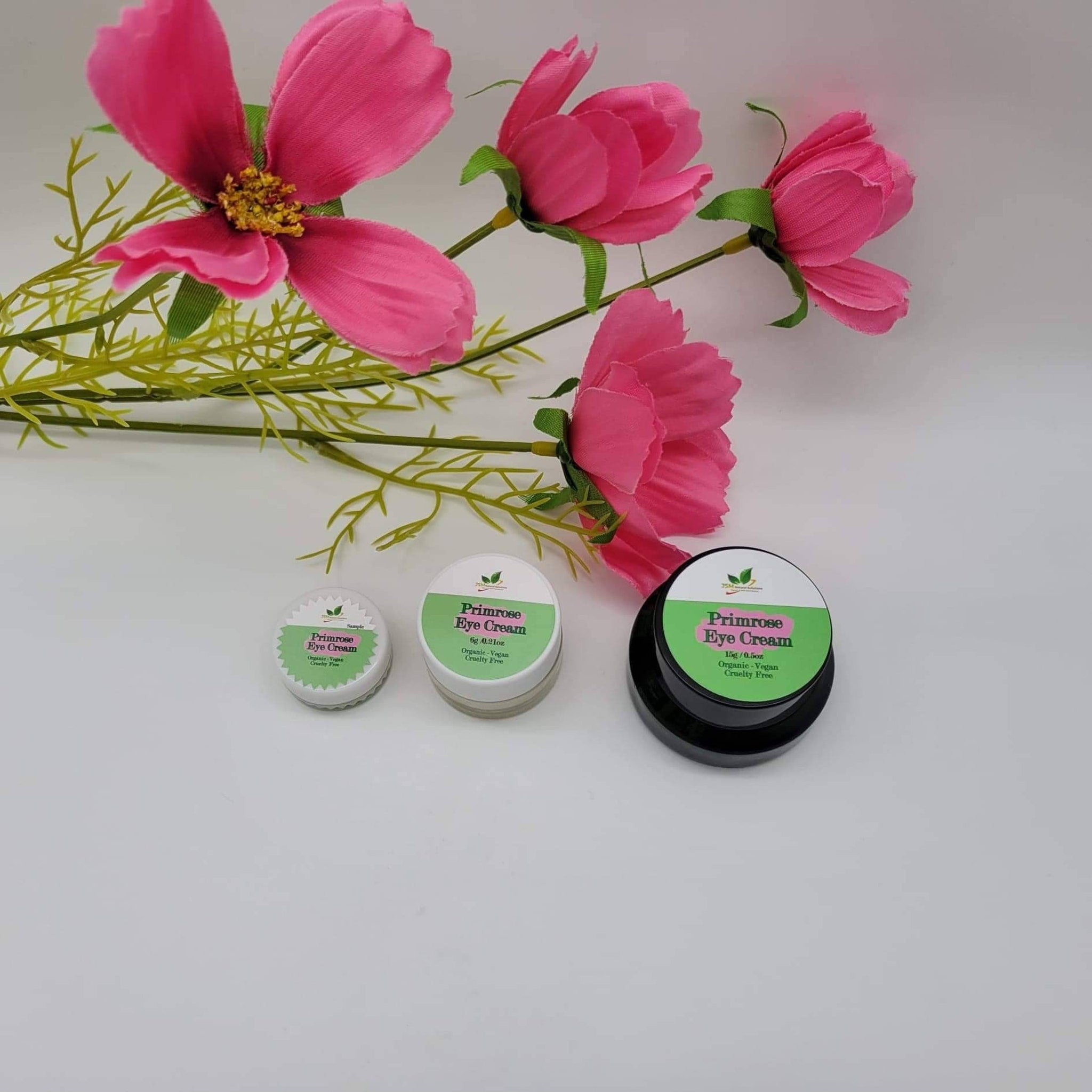 Primrose Eye Cream jars in white, black, and clear containers, with pink and green labels and flowers