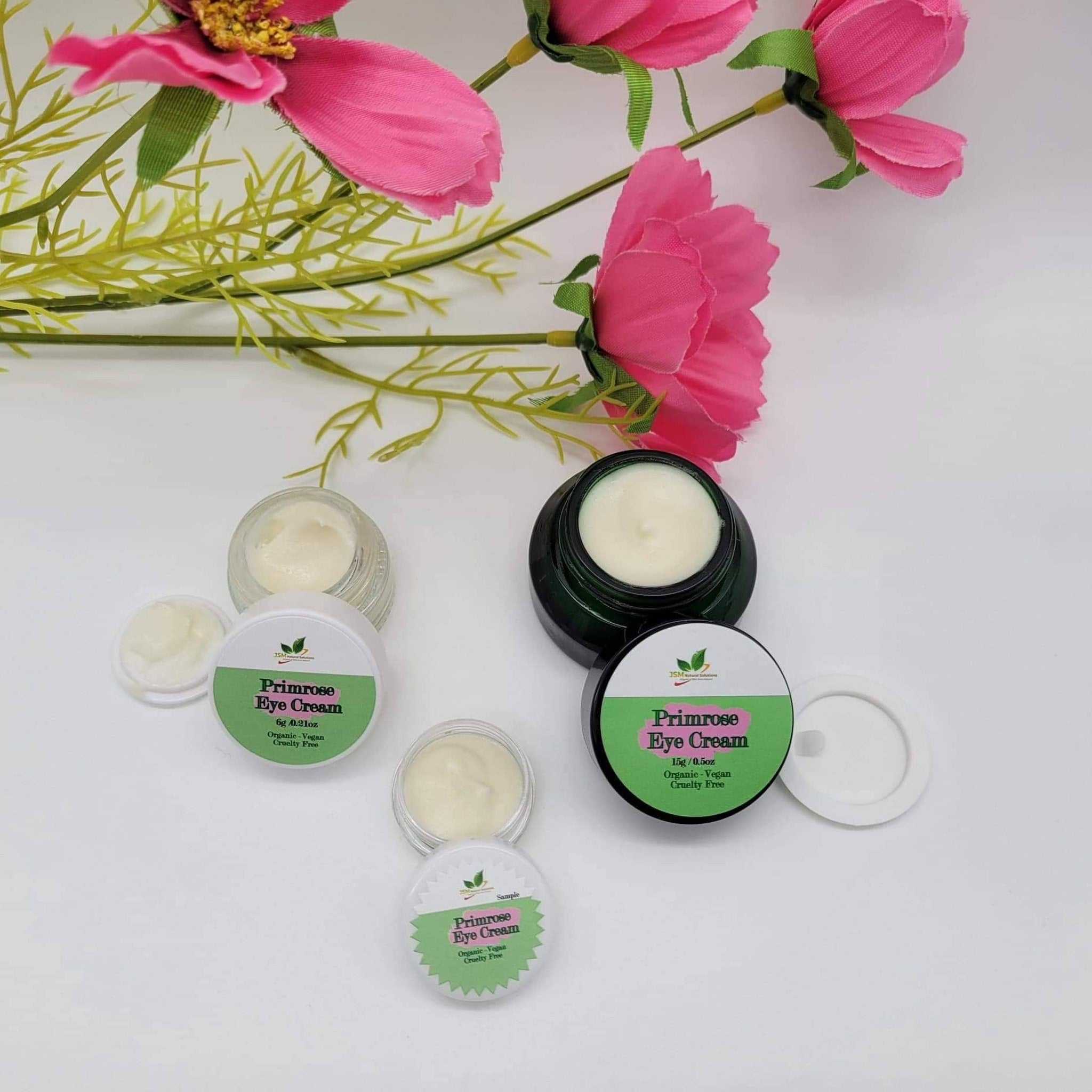 Primrose eye cream in clear glass jars with white cream and green labels with text