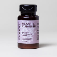 Facial cleanser bottle with black cap, brown glass, and purple label with text "ORA'S AMAZING HERBAL" and "REJUVI C CLEANSER