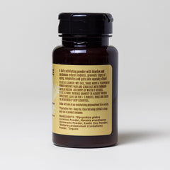 Exfoliating powder bottle, brown glass, black lid, with product label