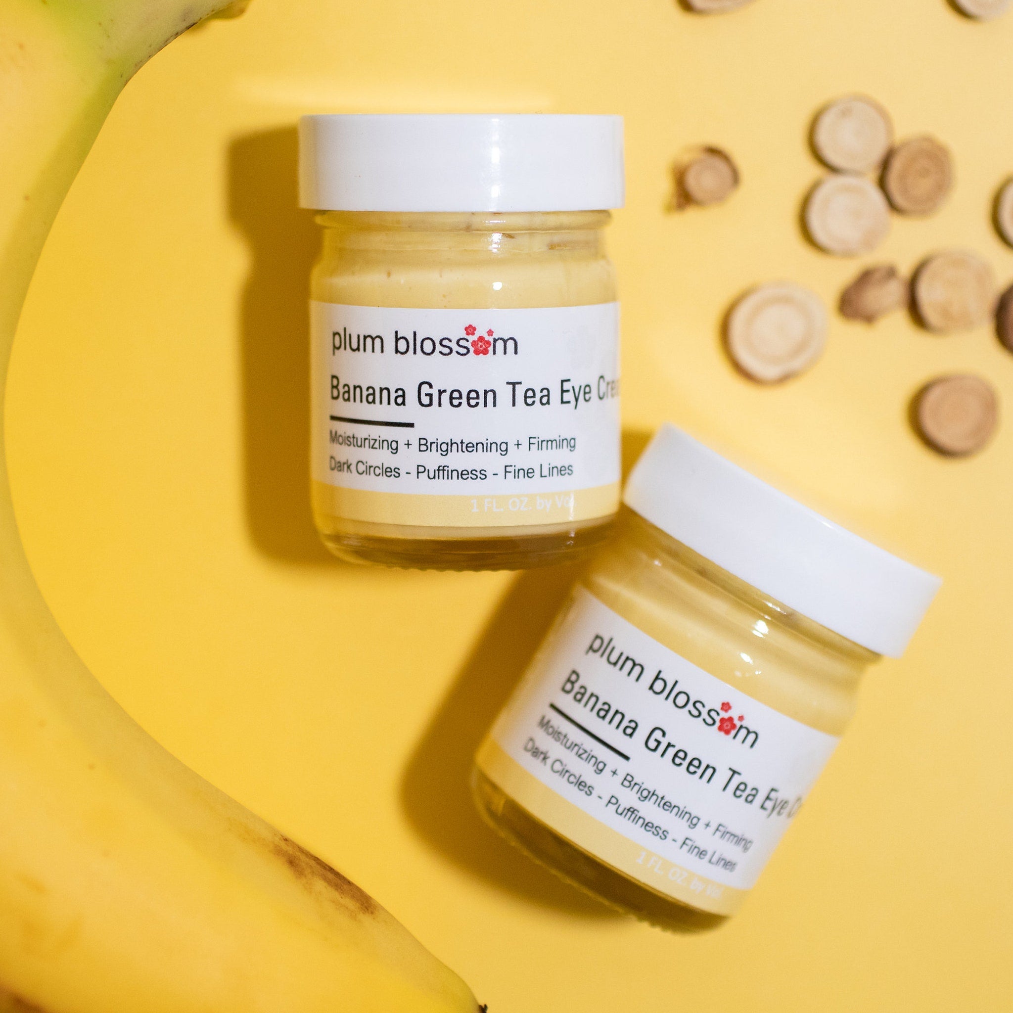Eye cream jars with white lids, yellow cream, and brand label on yellow background