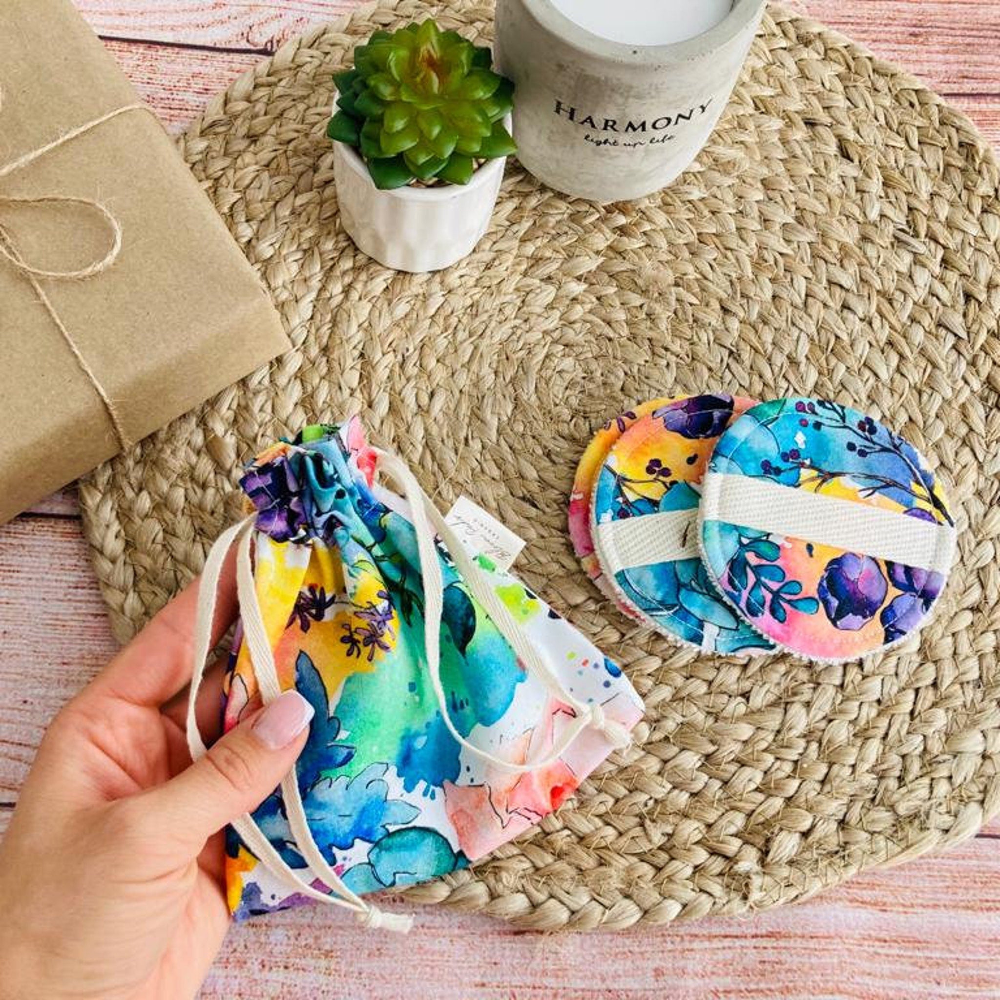 Reusable facial pads with floral pattern, white band, and drawstring bag with floral print