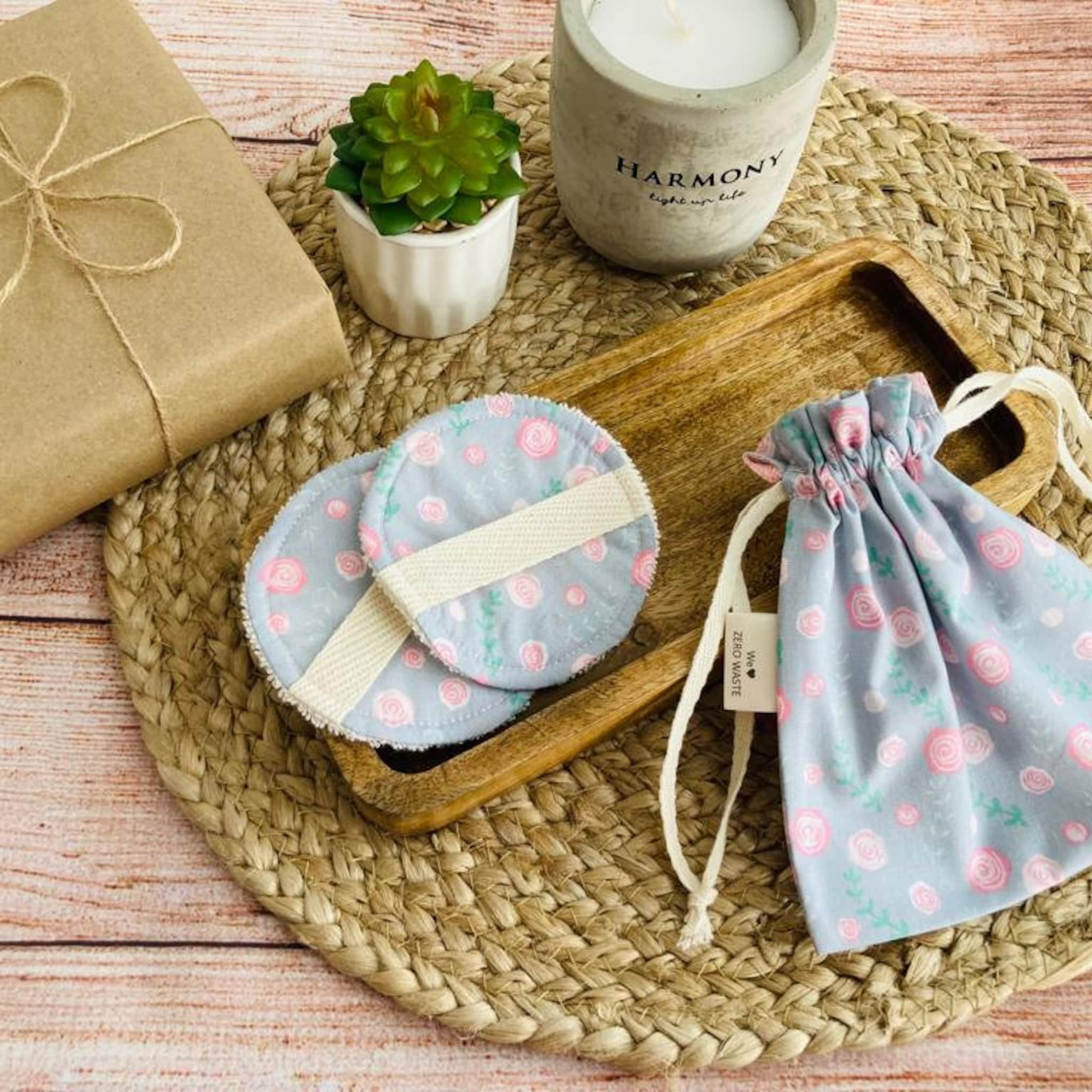 Reusable makeup remover pads with floral pattern and cream strap, with drawstring bag