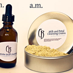 Cleansing grains in a silver tin, with light brown powder, and a brown glass bottle with a label.