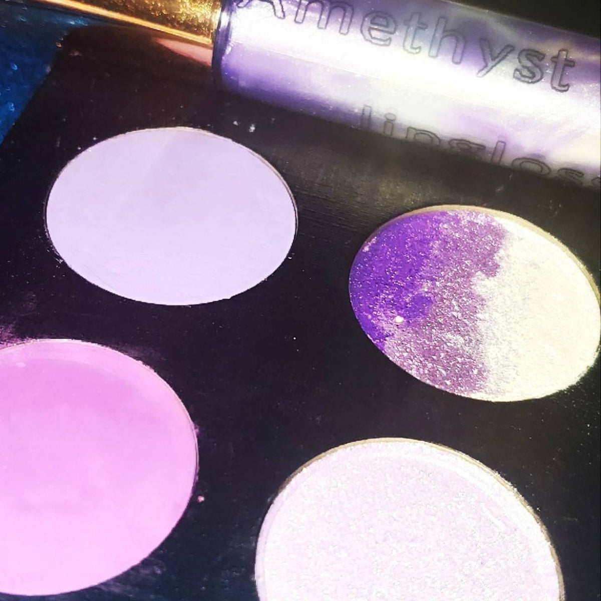 Amethyst Moon Eyeshadow Palette featuring 2 matte shades, 1 shimmer, and glitter in purple tones with sleek black packaging