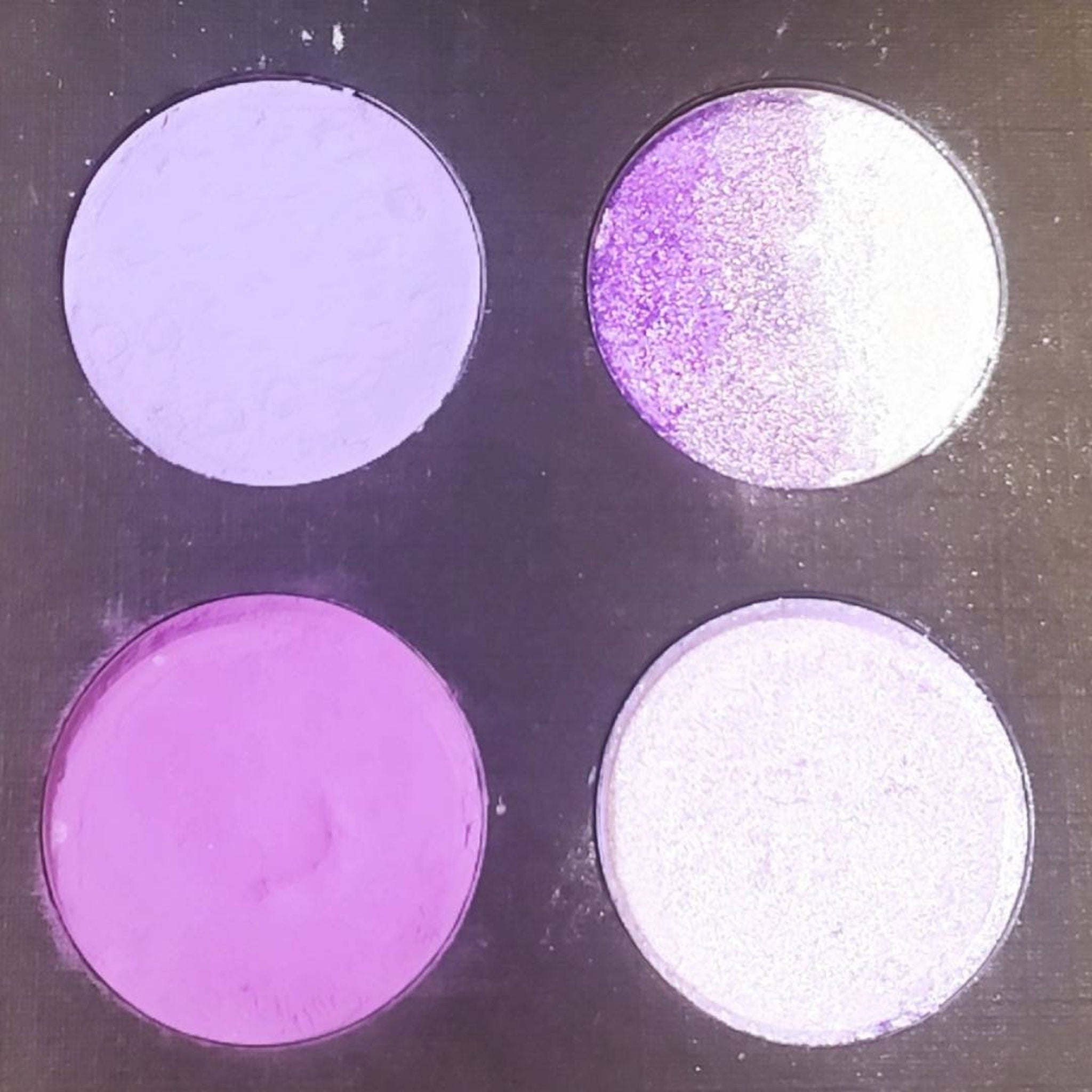 Side view of Amethyst Moon palette showing angled compact with 3 shadow pans in plum matte, lilac shimmer, and violet glitter