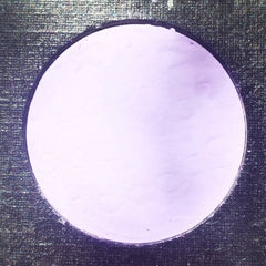 Side view of Amethyst Moon palette showing matte purple and shimmer silver eyeshadow pans in sleek black compact