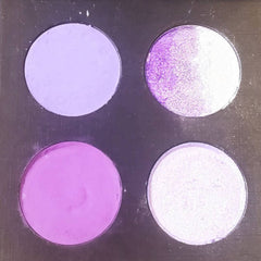 Close-up of amethyst purple matte and shimmer eyeshadows in compact palette with glitter particles
