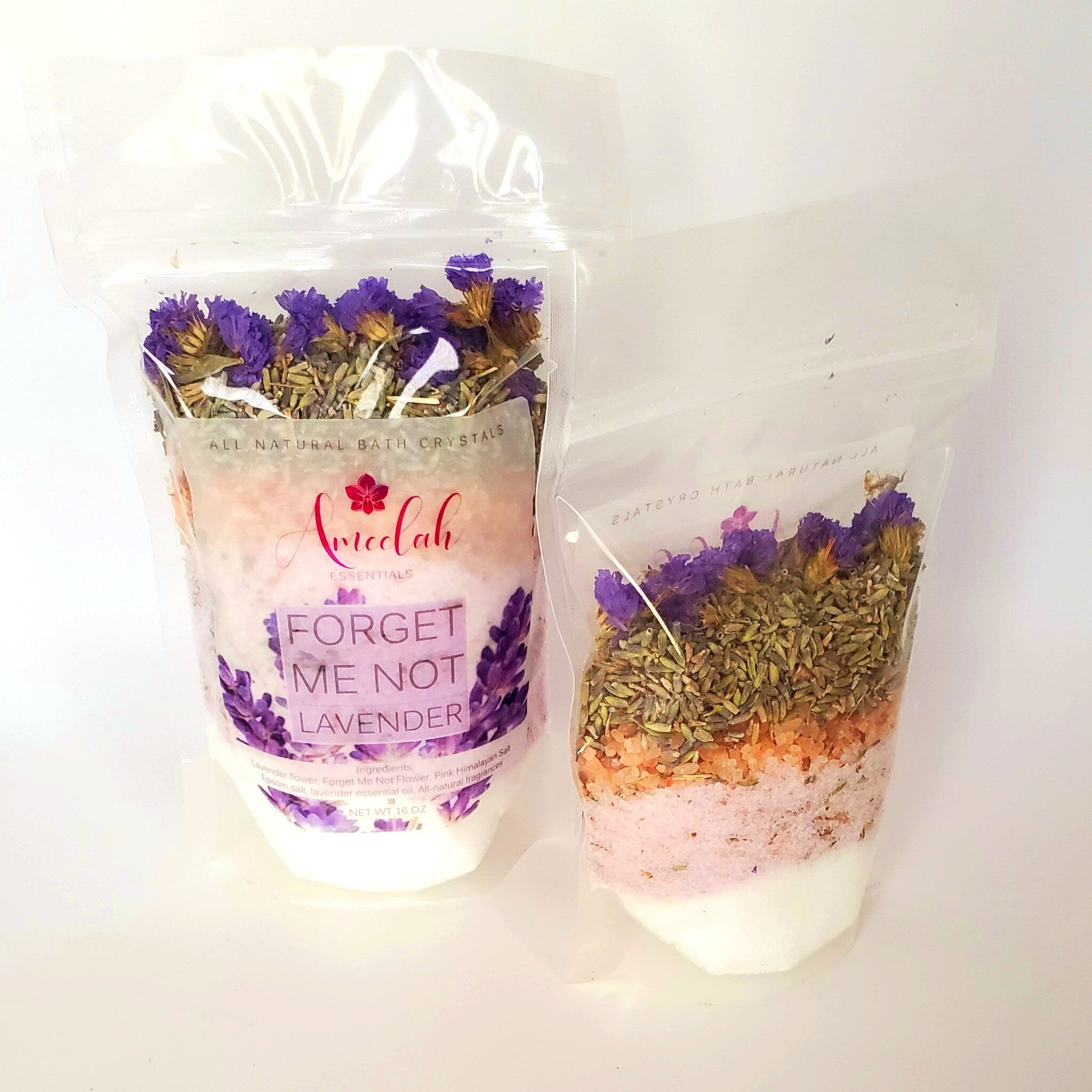 Bath crystals in clear plastic bags with purple flowers and pink salt layers, Amreelah brand