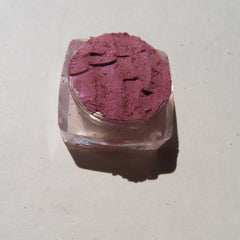 Side view of CHLOE Vegan Mineral Eyeshadow pot showing loose dark pink shimmer powder with cruelty-free label