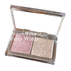 Compact duo eyeshadow palette with iridescent white and soft pink shades in minimalist packaging