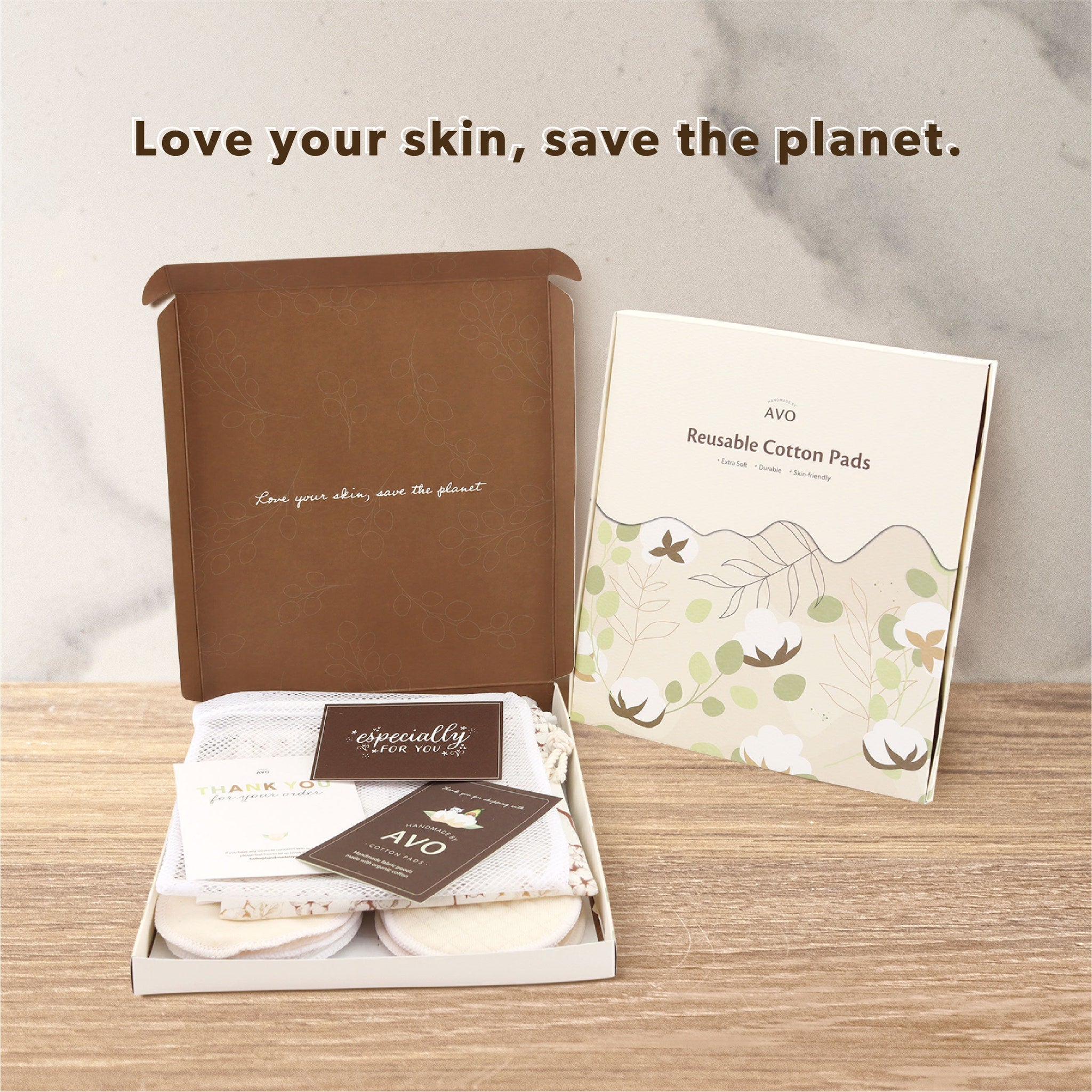 Reusable cotton pads in box, beige and white, with AVO branding and floral pattern on packaging