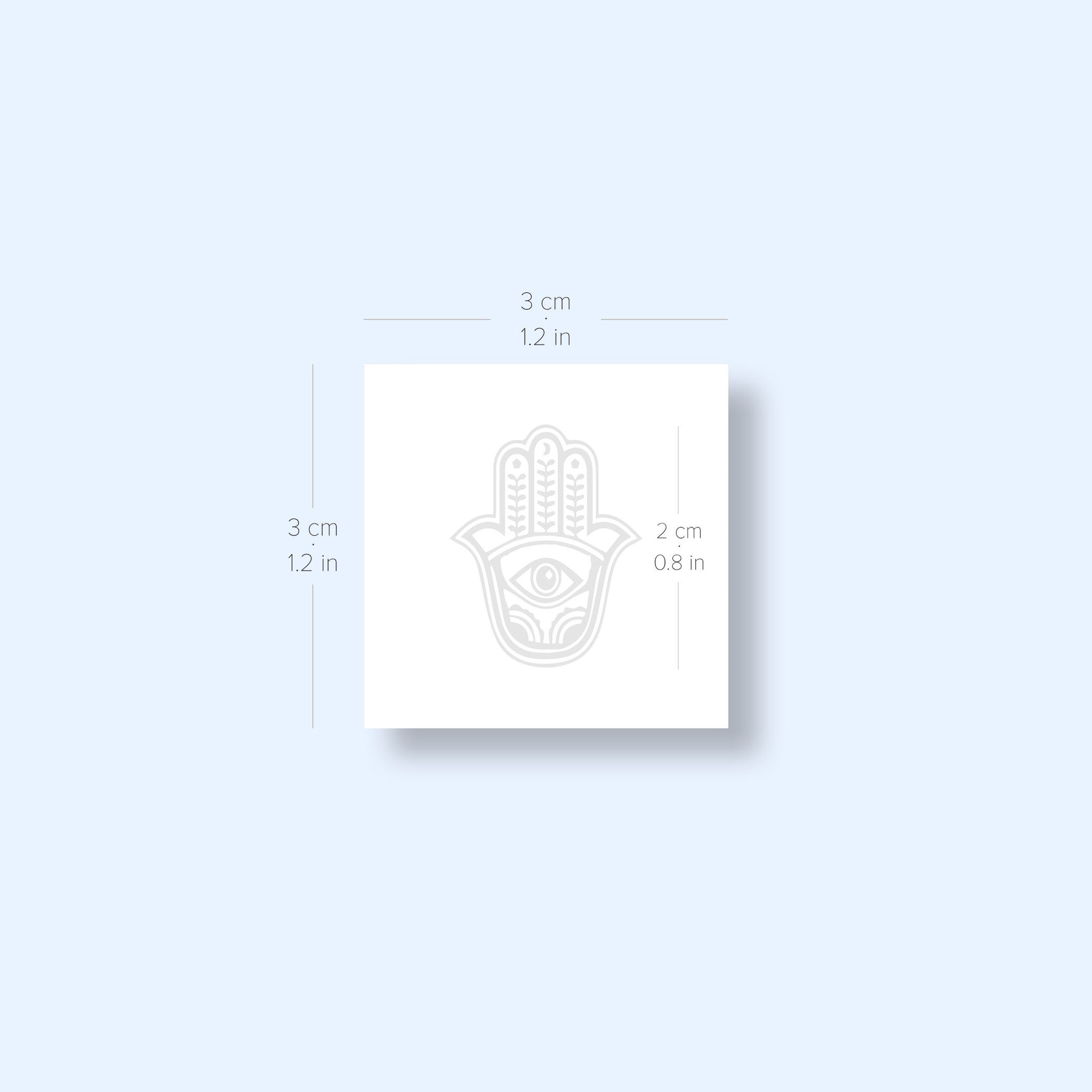 Close-up of two Hamsa tattoo stickers with intricate gold detailing on skin-safe adhesive backing