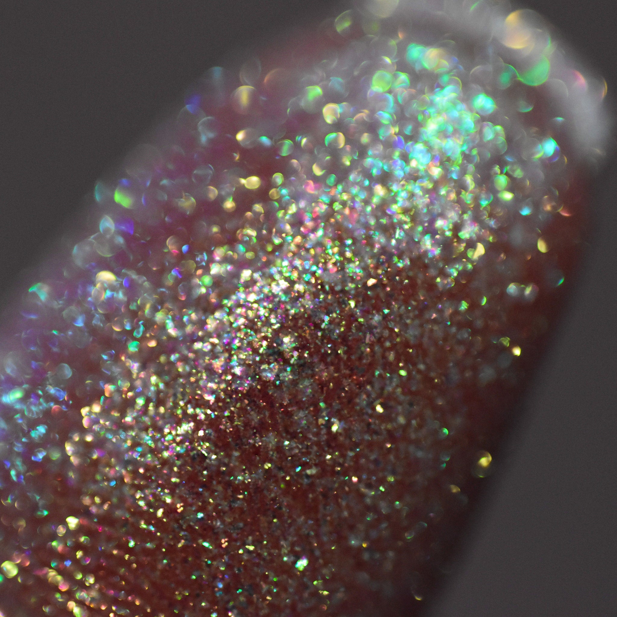 Extreme close-up of Moon Dust loose powder eyeshadow showing multichrome sparkle particles catching light