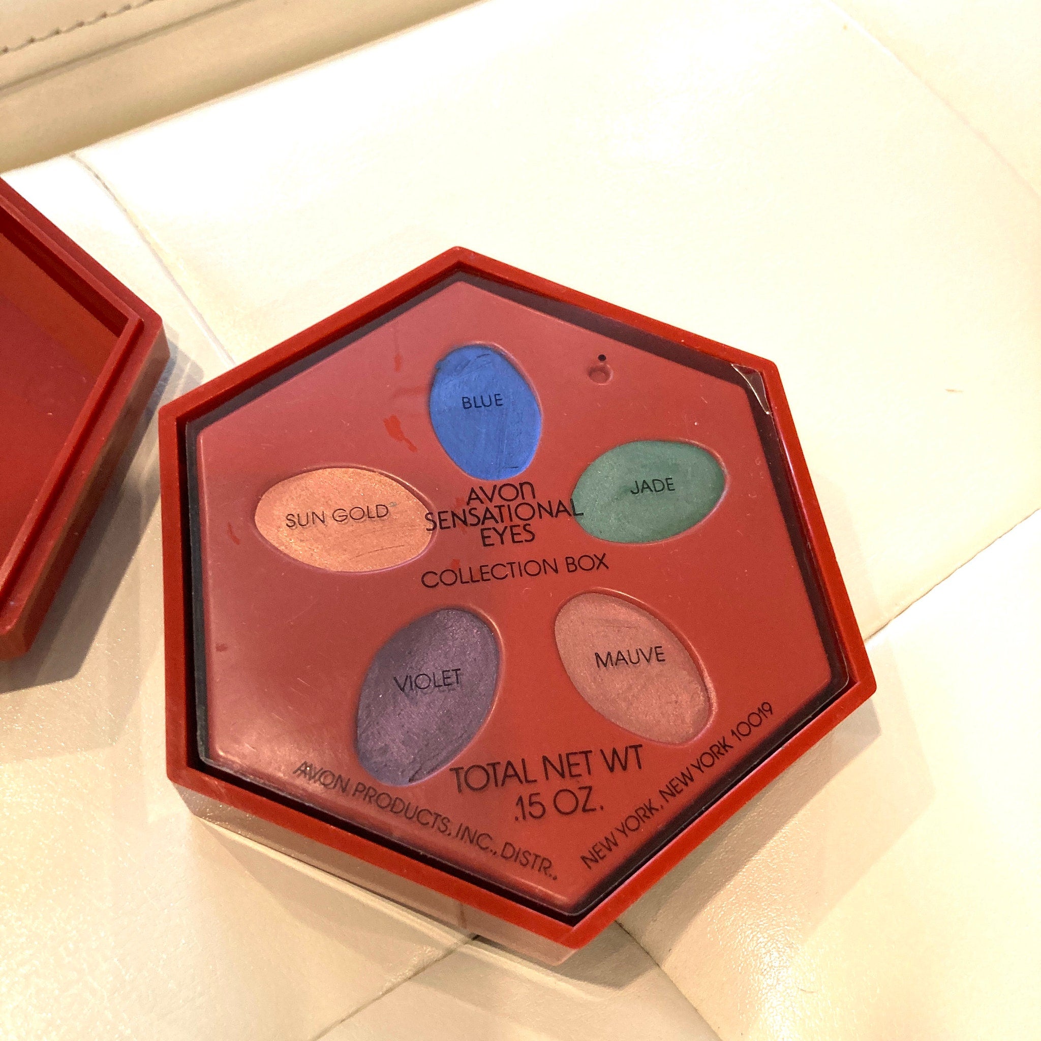 Close-up of Avon Sensational Eyes Vintage Collection eyeshadow palette showing shimmering bronze and plum shades
