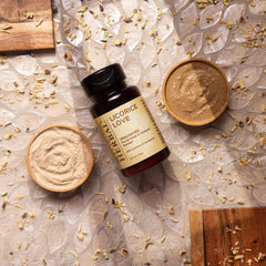 Facial cleanser powder with wooden bowls, licorice root pieces, and Ora's Amazing Herbal brand
