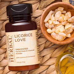 Facial mask powder bottle with brown glass, white label, and wood bowl of crystals on woven mat