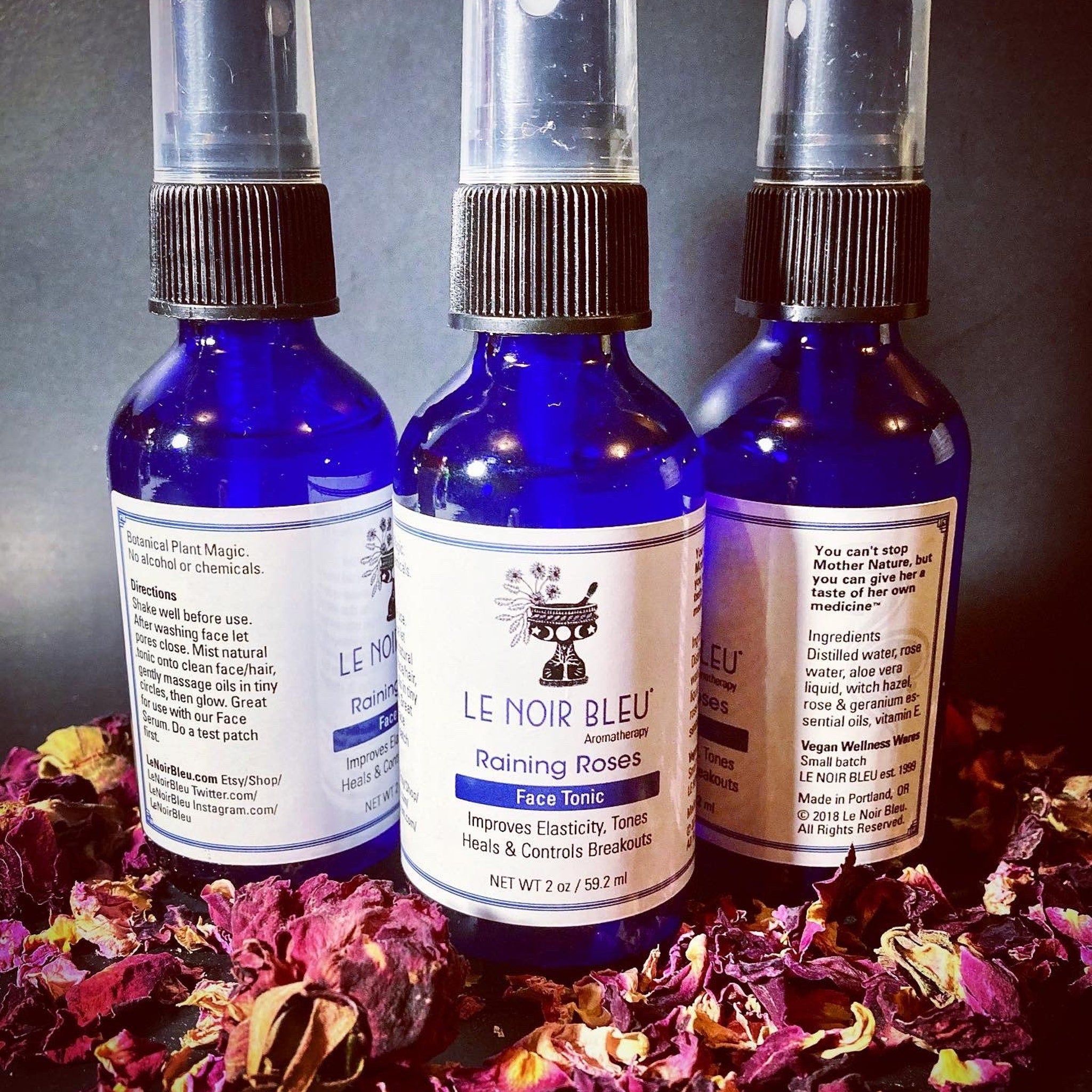 Face tonic bottles with blue glass, black caps, and white labels, "Le Noir Bleu" brand