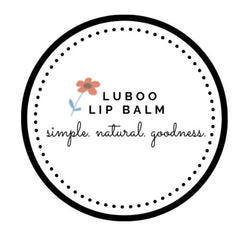 Lip balm logo with black circle border and dotted pattern, flower illustration, and "Luboo" text