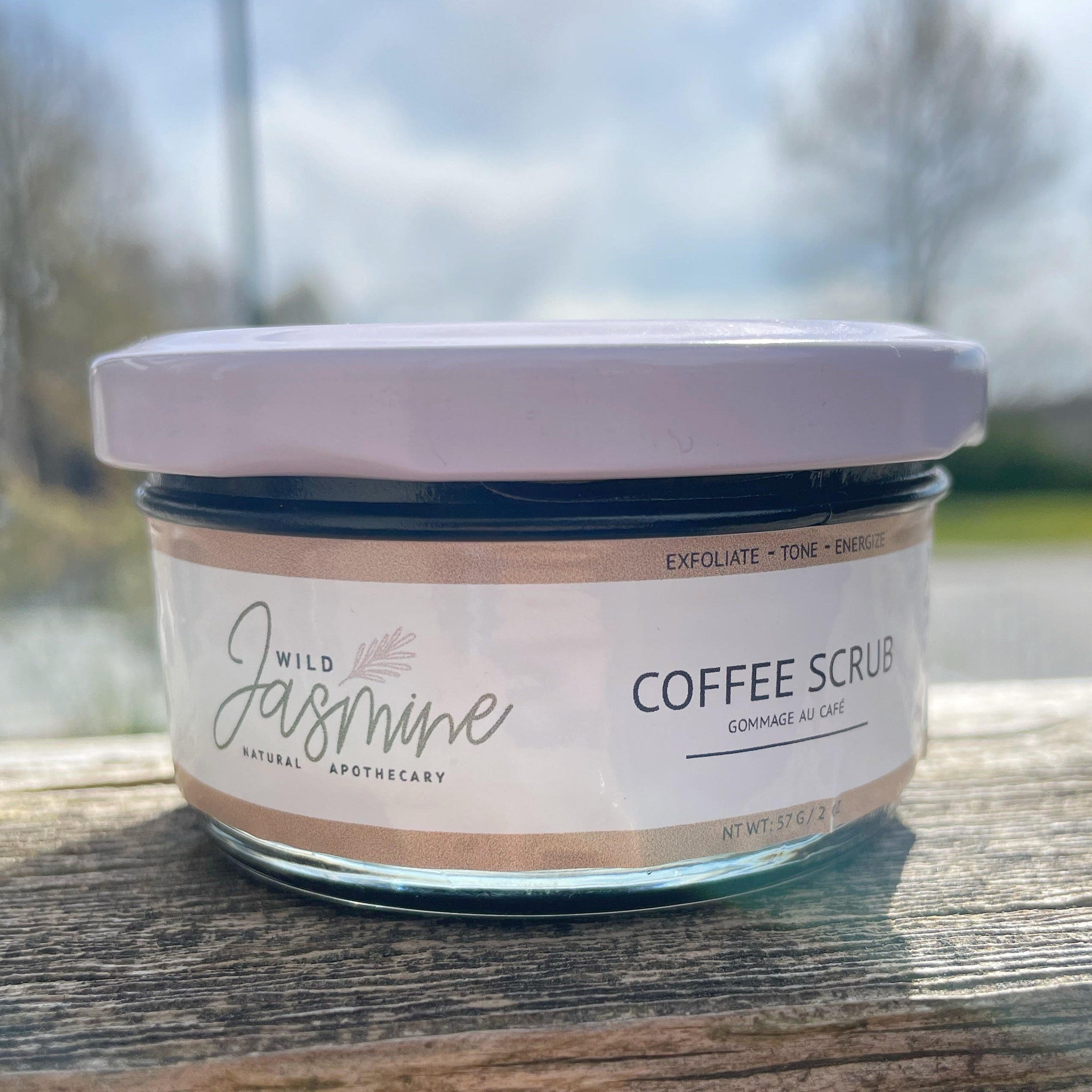 Coffee scrub jar with white lid, glass jar, and Wild Jasmine label