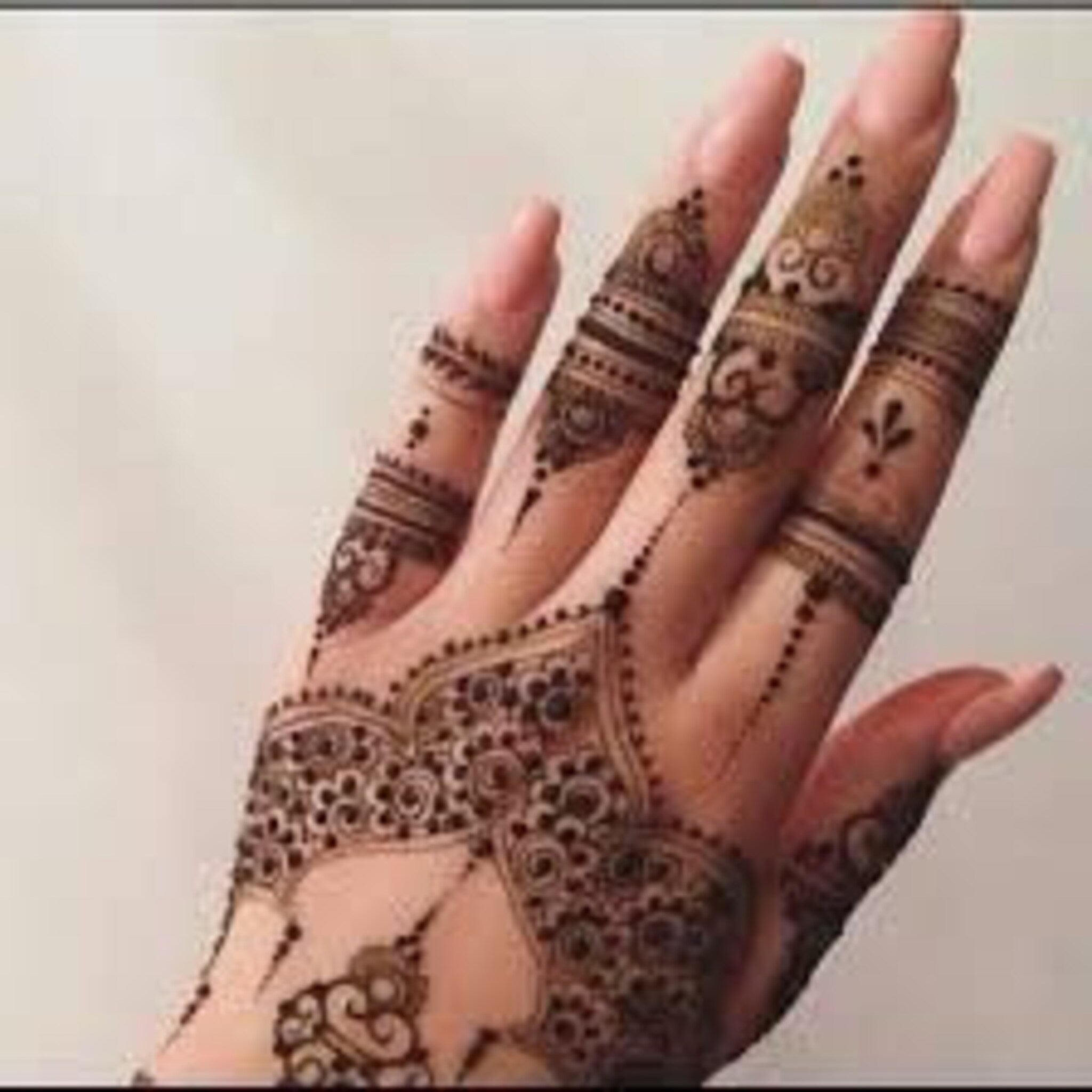 Close-up of natural brown henna cone with textured surface and earthy tones, showcasing organic skincare detail