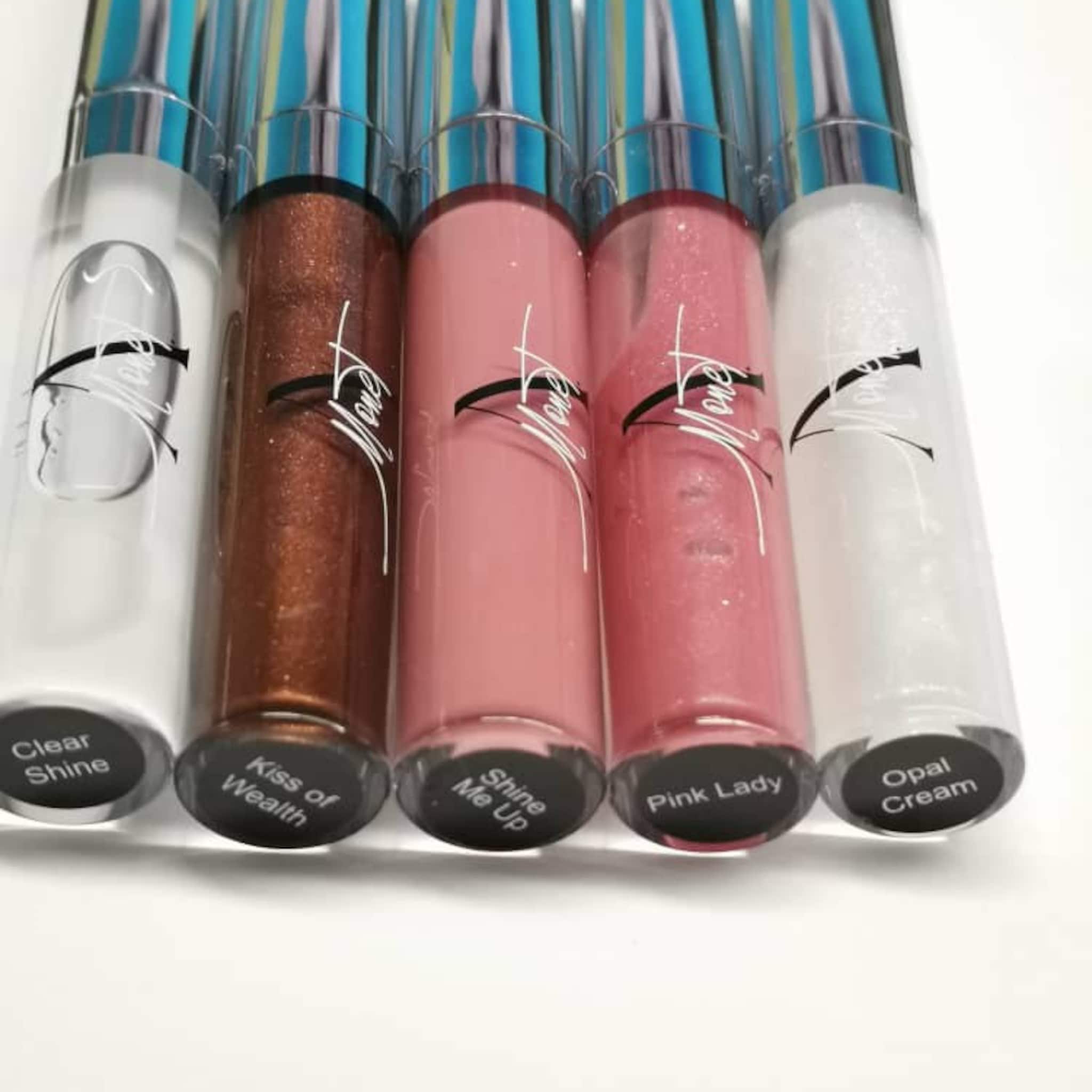 Lip gloss tubes in clear, brown, pink, and white with silver and blue accents, Mone brand name visible