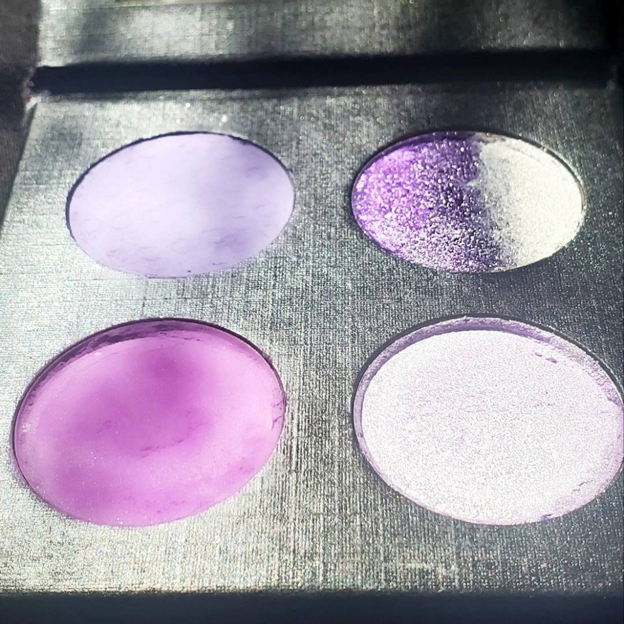 Side view of Amethyst Moon palette showing stacked matte purple and shimmer silver eyeshadow pans