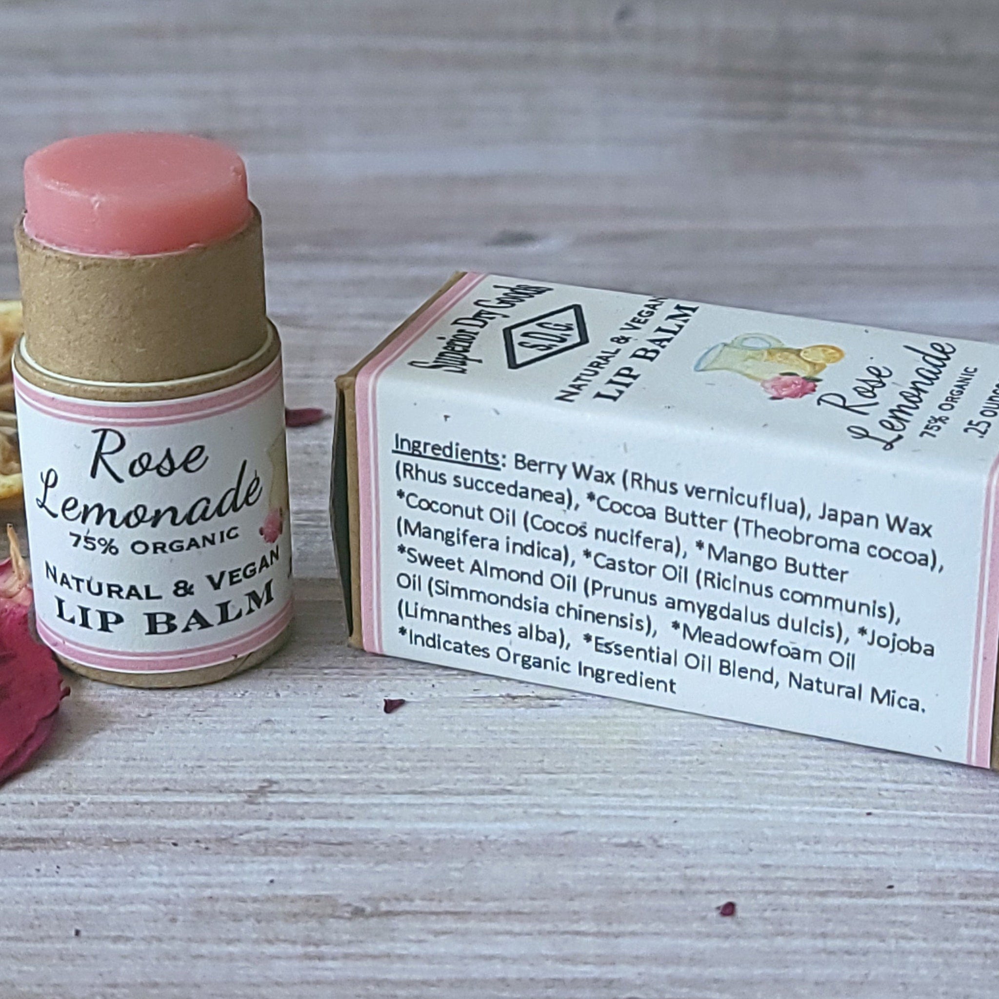 Lip balm with pink color, cardboard tube, and Rose Lemonade text on packaging