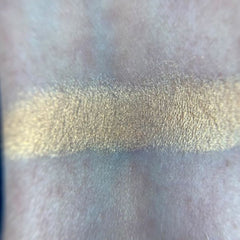 Close-up of May Eyeshadow palette showing shimmering bronze and taupe shades with smooth, blendable texture