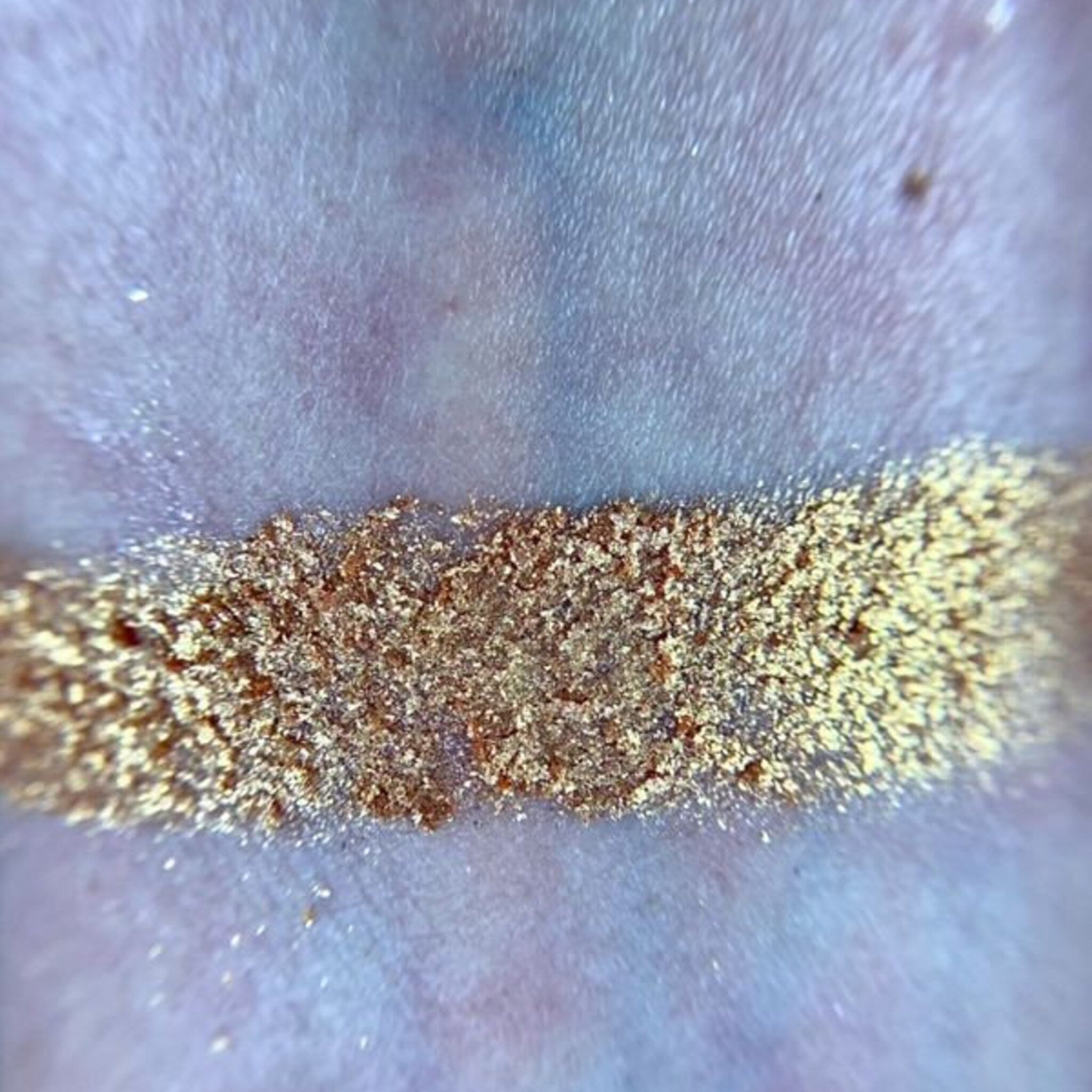 Side view of Harvest Moon palette showing sleek black compact with gold moon emblem