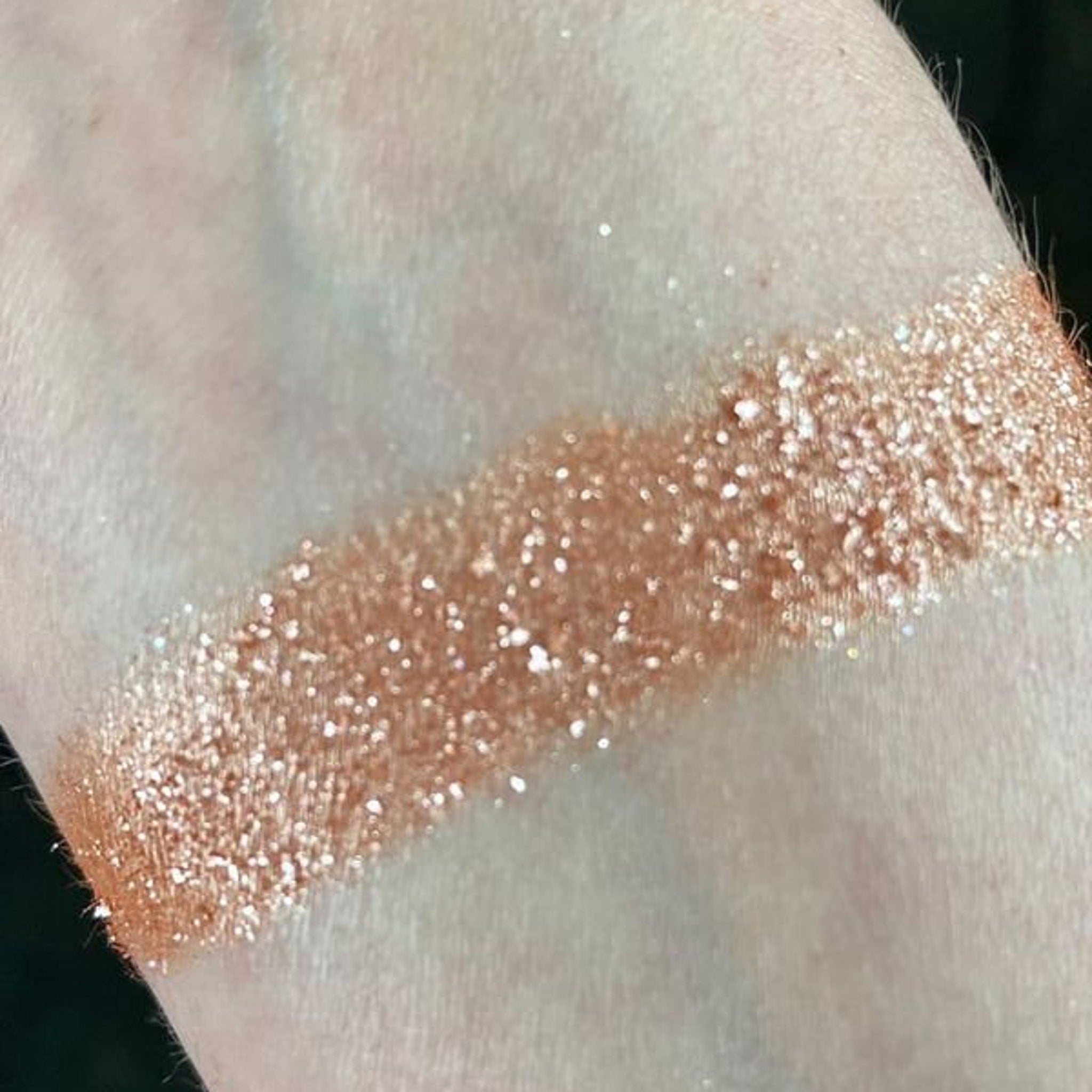 Front view of Io Eye Shadow Palette showing sleek black compact with gold logo and visible shade range