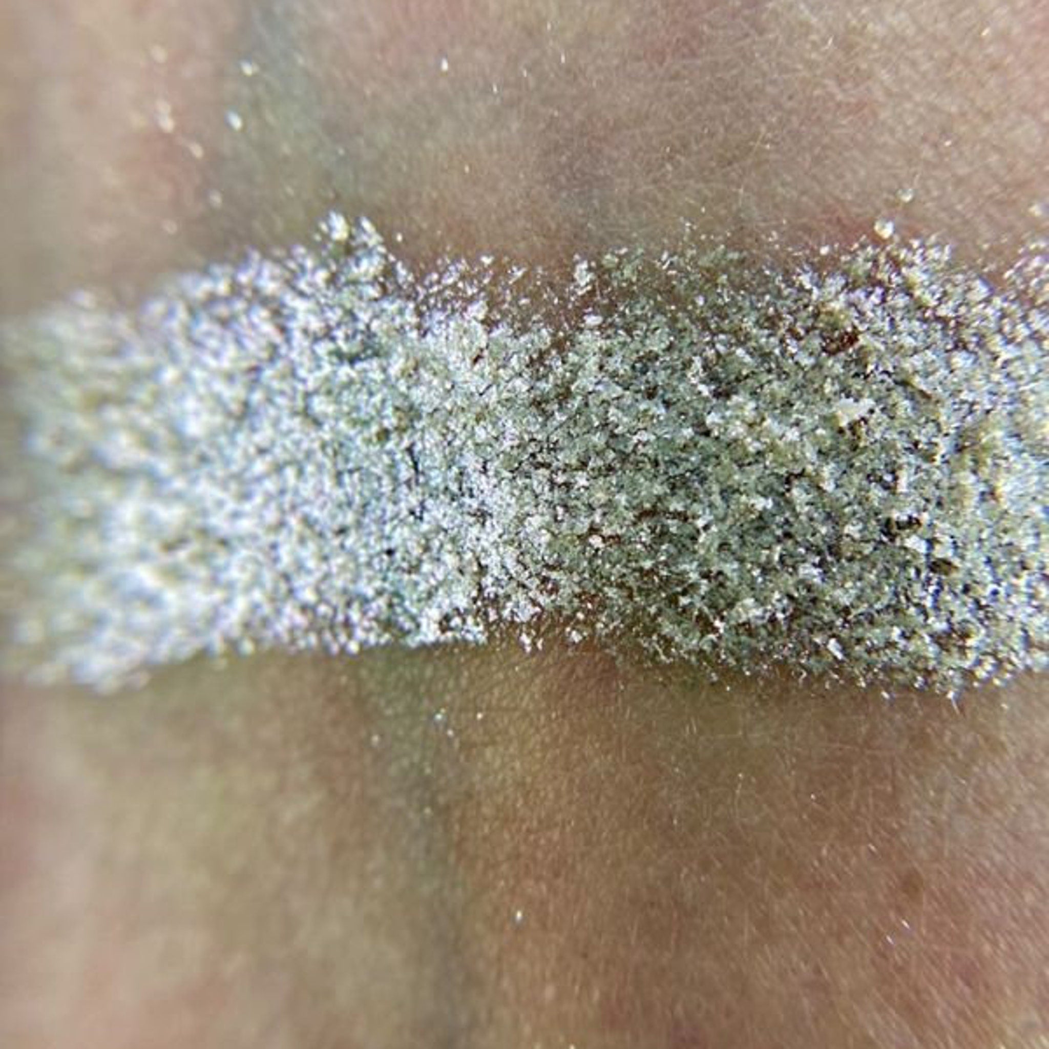 Side view of Iapetus Eye Shadow Palette showing sleek black compact with gold trim and embossed logo