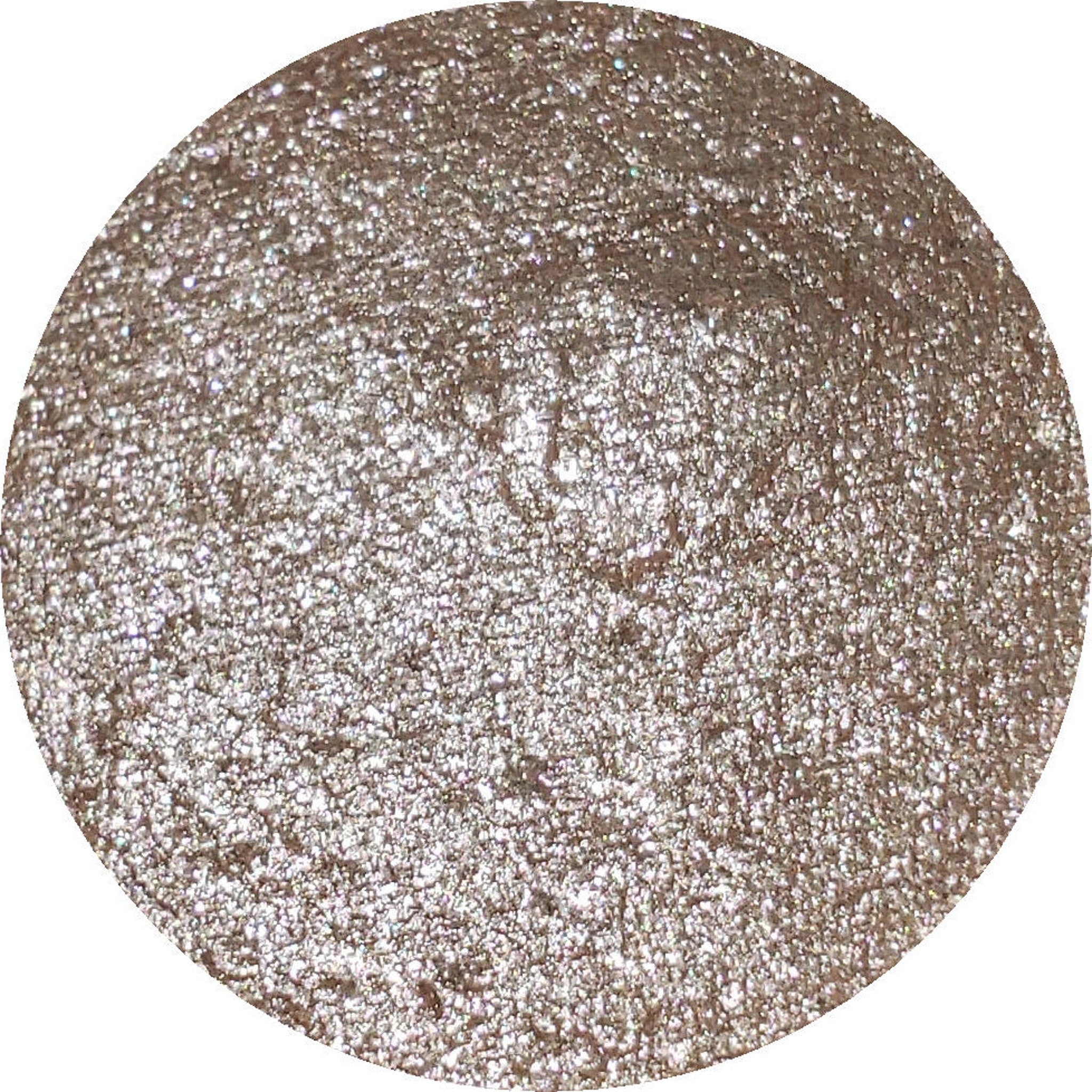 Close-up of Iapetus Eye Shadow Palette showing shimmering bronze and plum shades with smooth, blendable texture