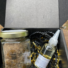 Beard oil and scrub gift set in black box with gold accents and Madame Gray text