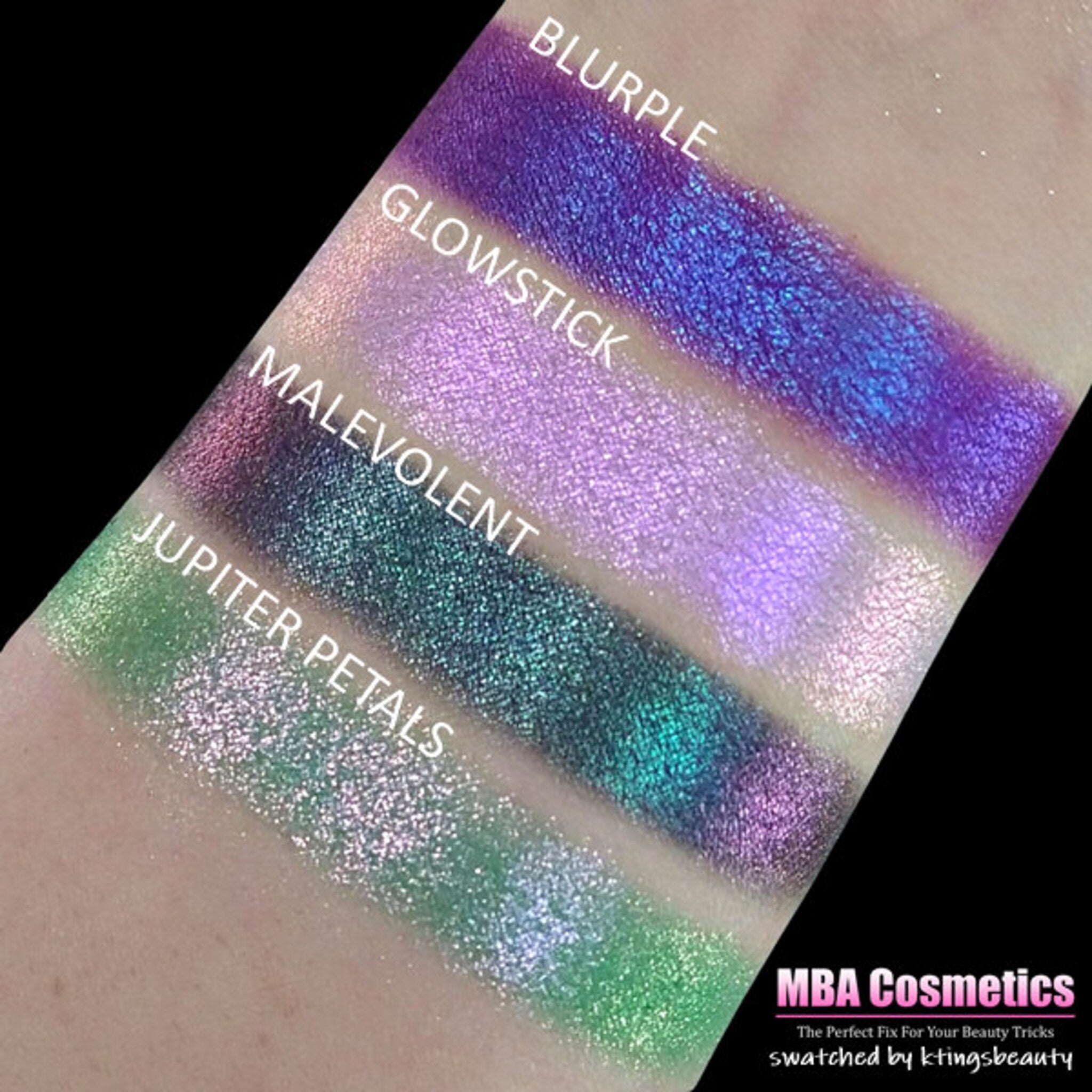 Side view of duochrome blurple eyeshadow pan showing color shift from purple to blue in compact packaging
