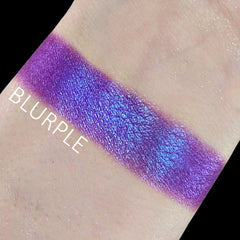 Close-up of duochrome blurple eyeshadow shifting between blue and purple hues in compact pan
