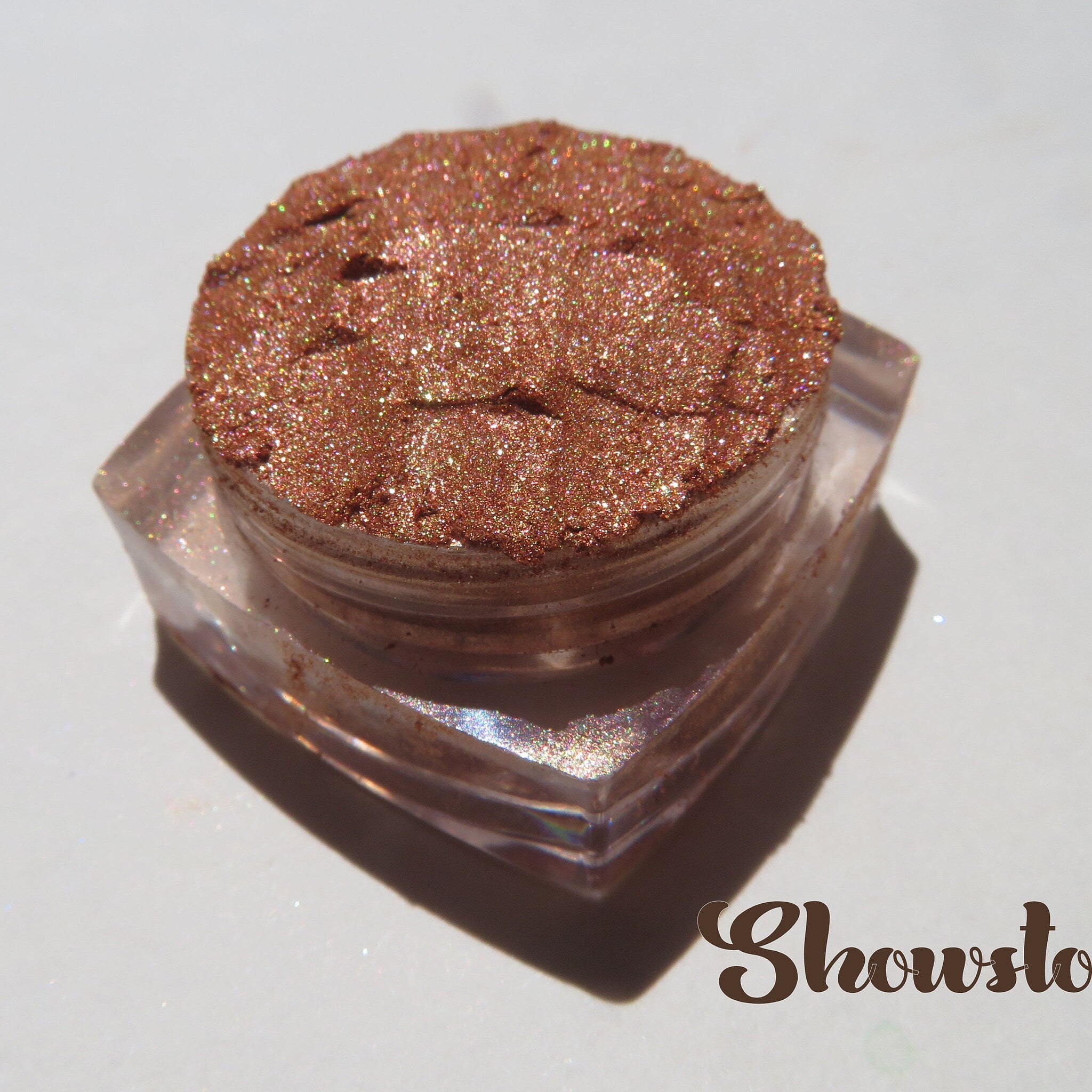 Close-up of Tigerlily shade from fall brown eyeshadow set showing vegan shimmer texture in pan