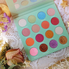 Close-up of the Secrets of the Earth Eye Shadow Palette showing 12 vibrant matte and shimmer shades in earthy tones