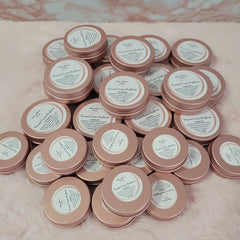 Lip balm tins, rose gold metal, white label with Ouulattesbeauty text, stacked together