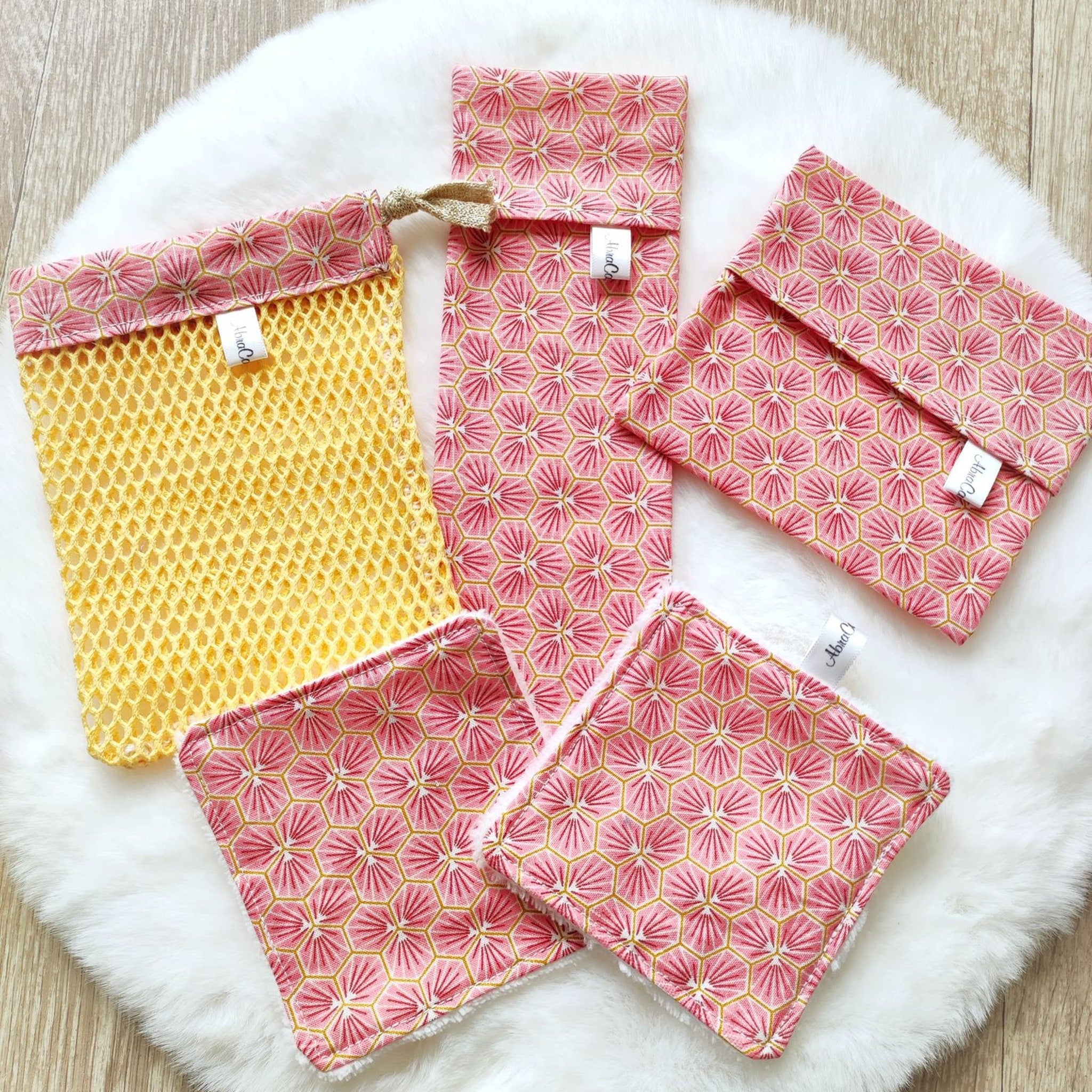 Eco-friendly soap net and washable sponge nestled in sleek travel cases, angled to show texture details