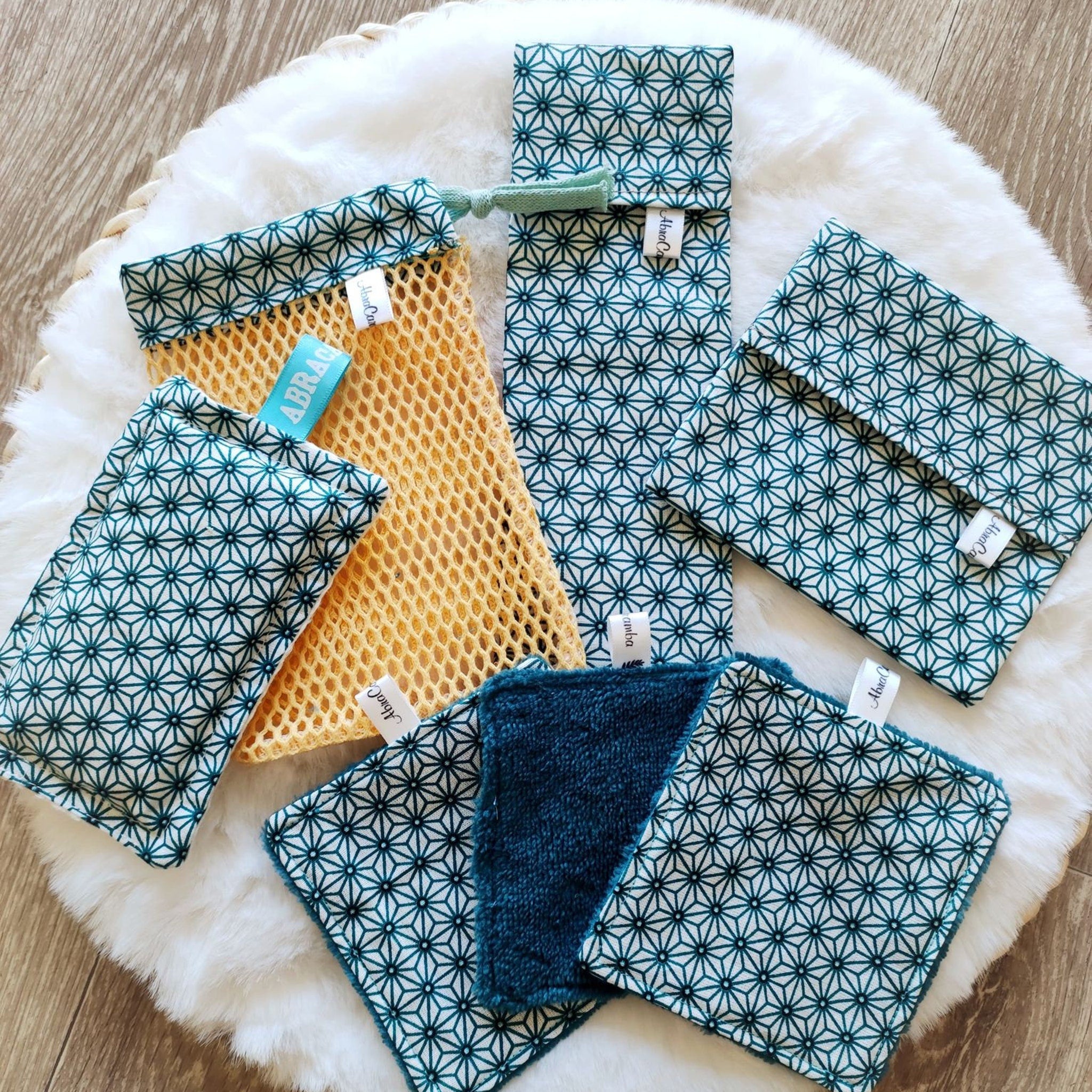 Side view of zero waste beauty kit showing soap net, washable sponge, and travel cases in neutral tones