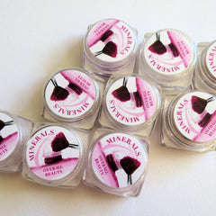 Side view of 10 vegan mineral eye shadows in assorted matte and shimmer shades with loose powder eyeliners