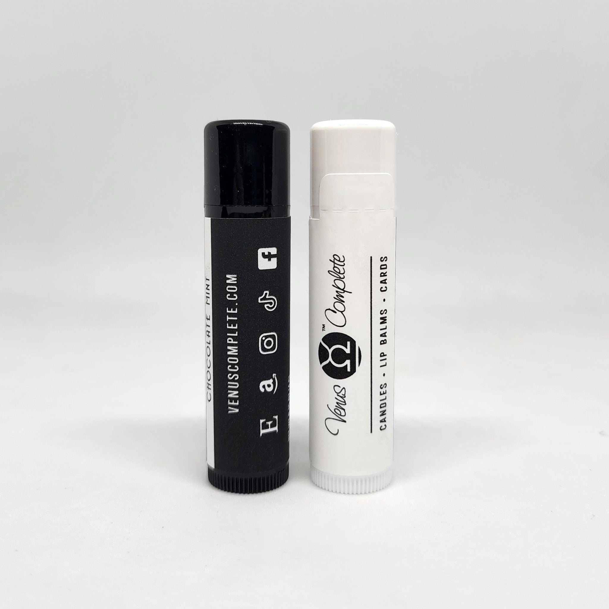 Lip balm tubes, black and white with Venus Complete branding, for lip care