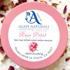 Rose petal salve in a pink container with white label and floral design, by Agape Naturals