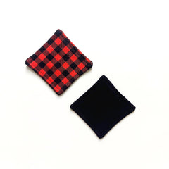 Diamond-shaped coasters with red and black plaid pattern, and a solid black coaster