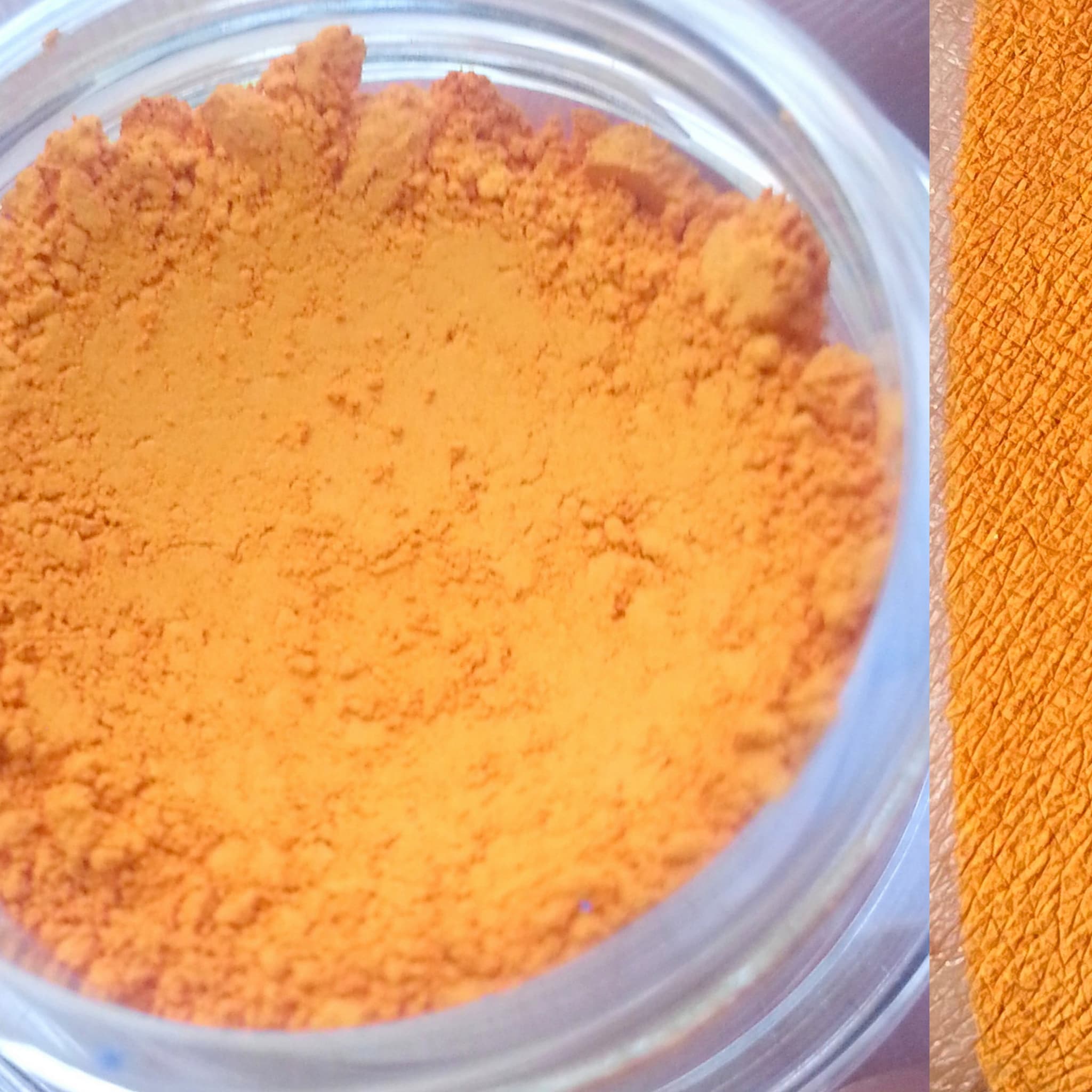 Matte eyeshadow, orange powder in jar and swatch, close-up view