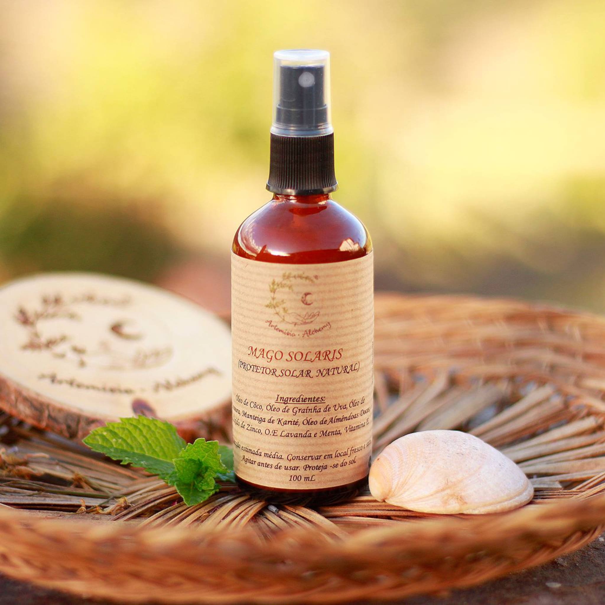 Sunscreen spray bottle with brown glass, paper label, and black cap, on a woven basket