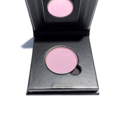 Close-up of pressed mineral eyeshadow compact showing smooth matte finish in soft neutral shade