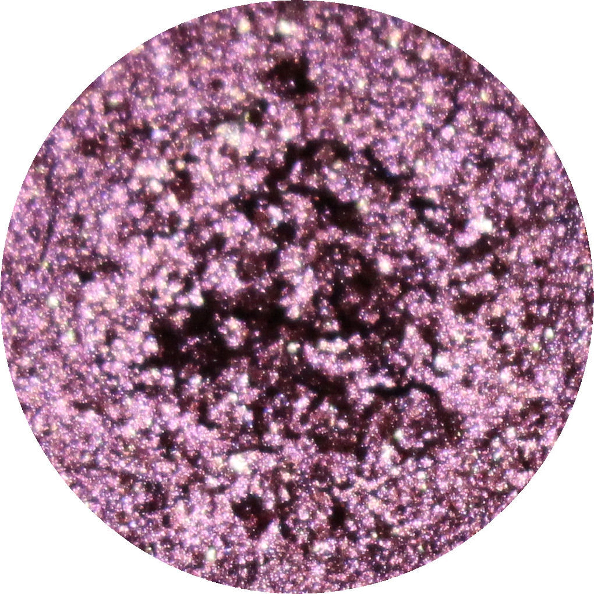 Close-up of makeup brush applying shimmery bronze eyeshadow from palette to eyelid