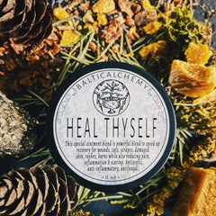 White plastic jar of healing balm with gold lid and minimalist label, 2oz size